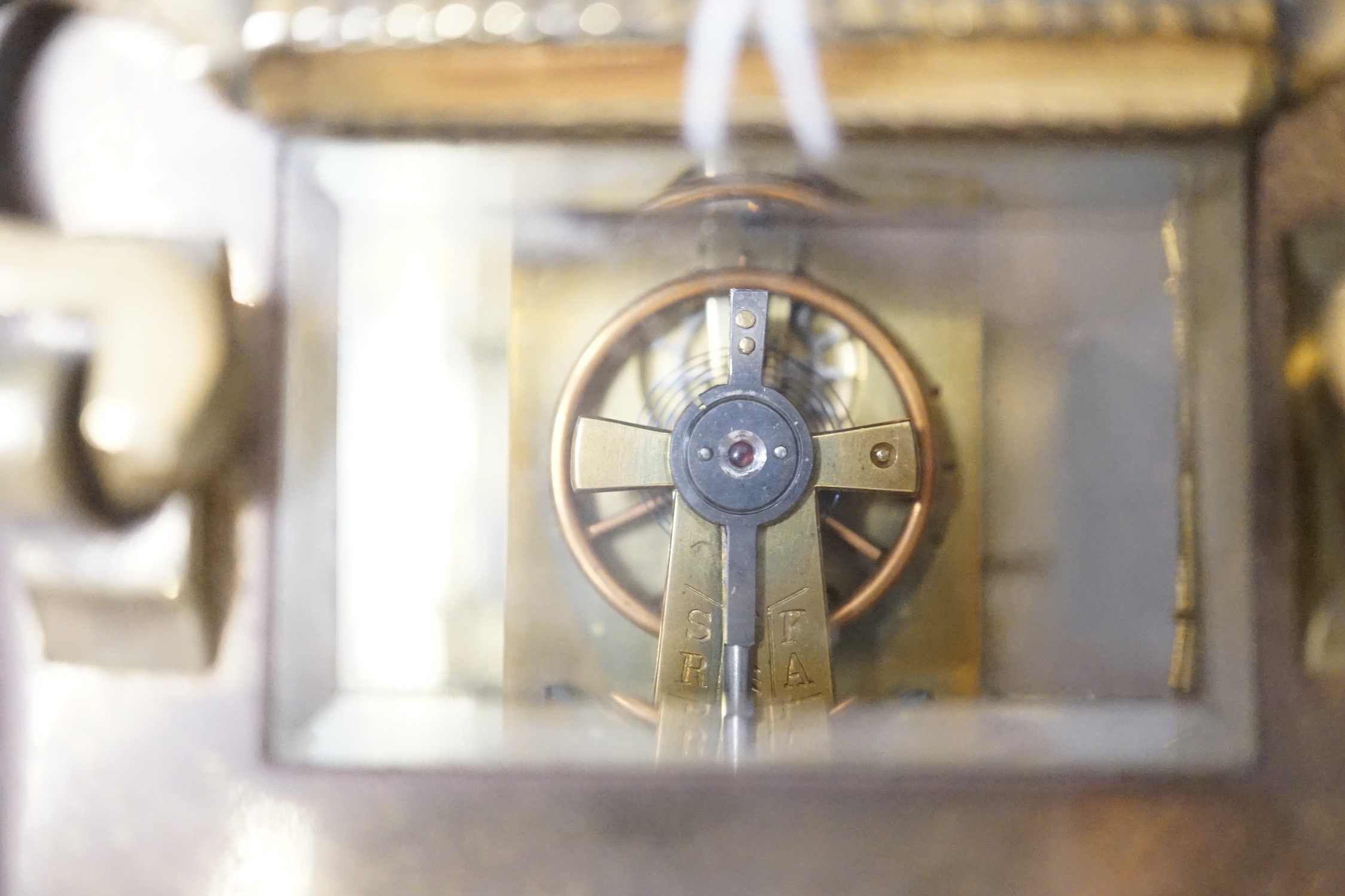 An Edwardian brass carriage timepiece, with pearl applied dial, 12cms high